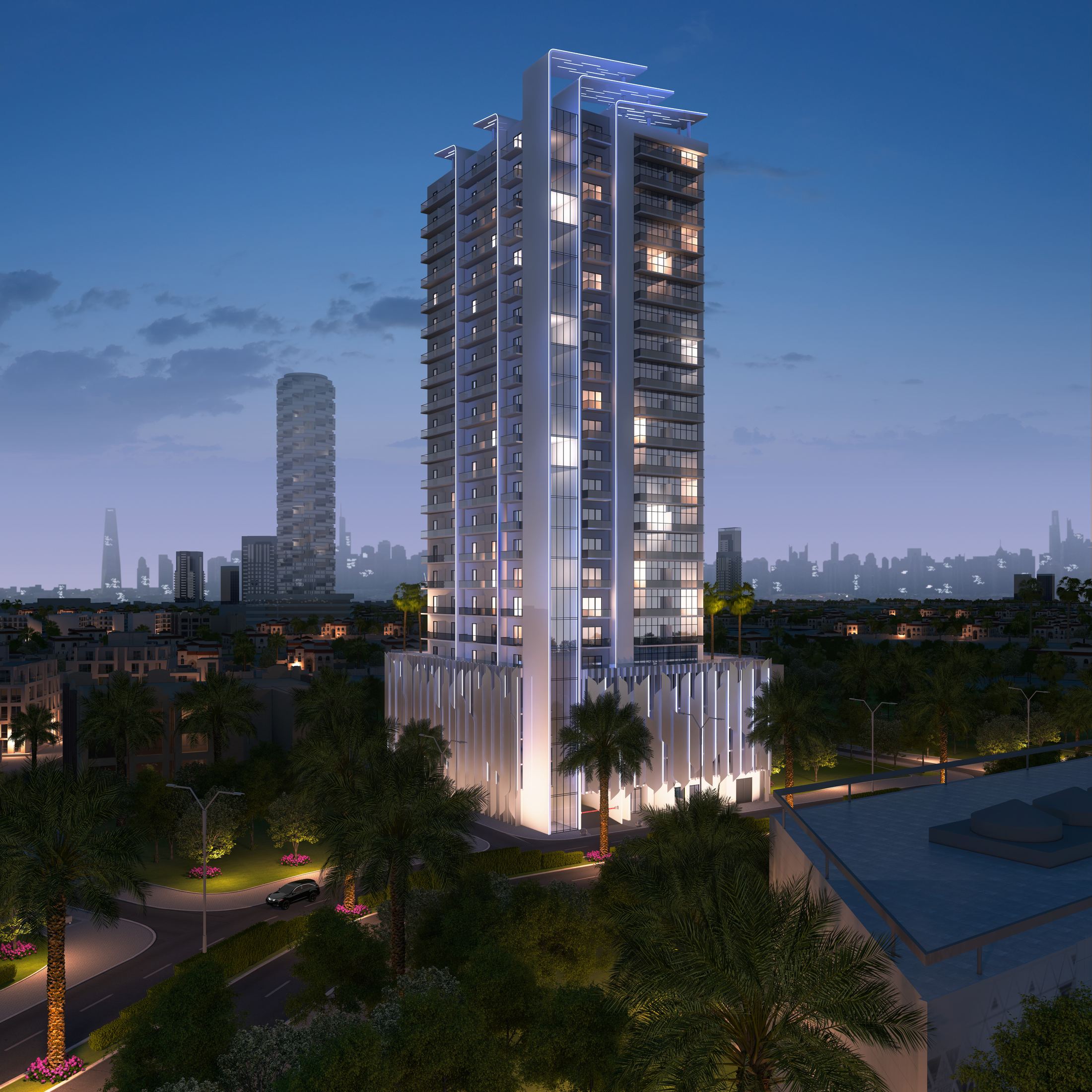 ŚVN tower at dusk — illuminated against the JVC skyline